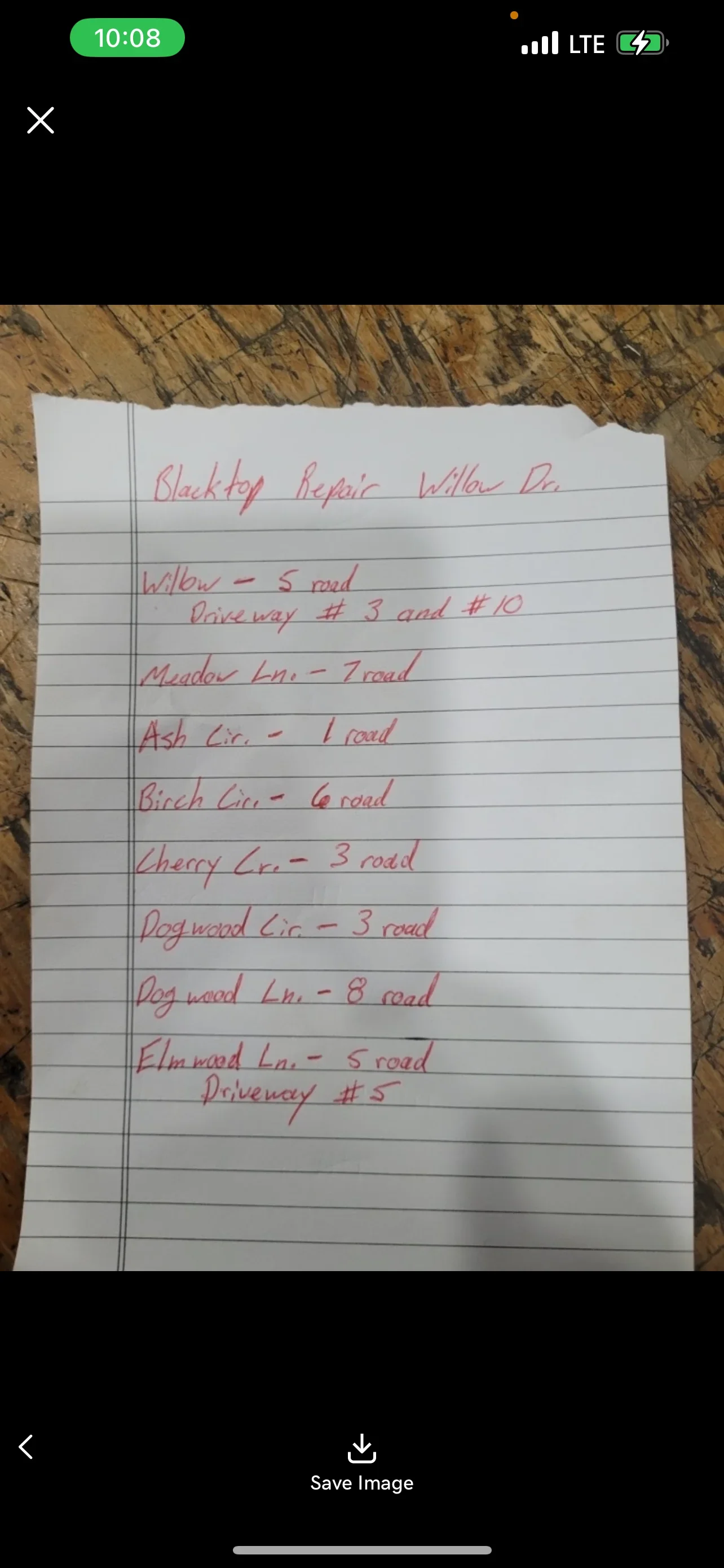 Handwritten project notes detailing blacktop repair locations and driveway numbers